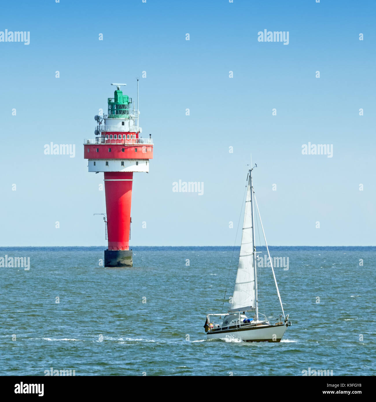 Red lighthouse and sailing boat on river Weser Stock Photo - Alamy