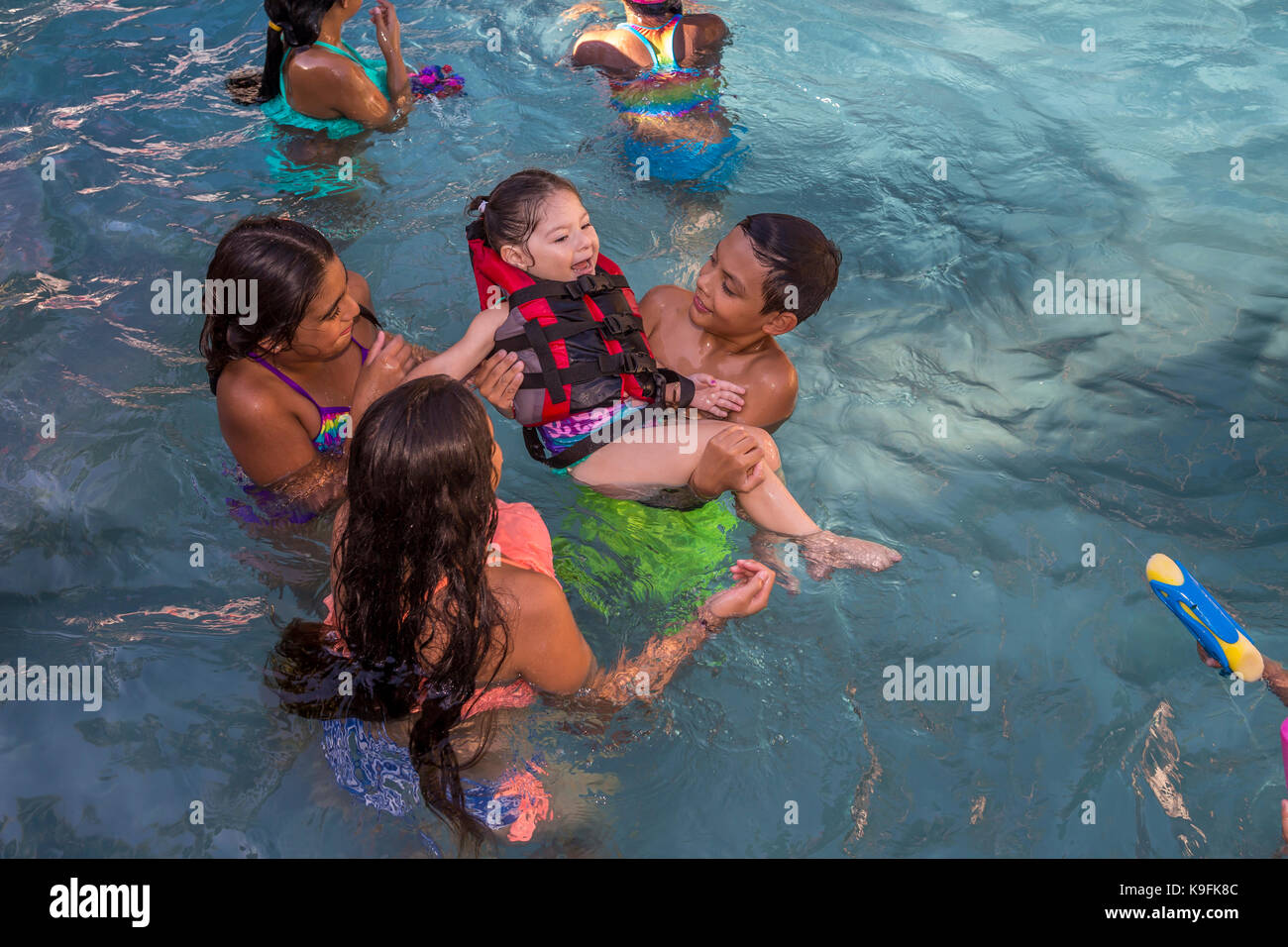 Hispanic children, boys and girls, playing in swimming pool, swimming pool, fresh water swimming pool, Castro Valley, Alameda County, California Stock Photo