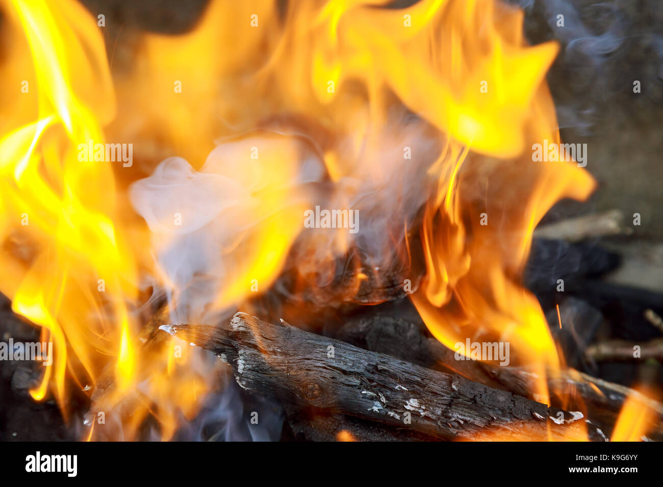 three burning billets in hot stove burn fire wood Stock Photo - Alamy