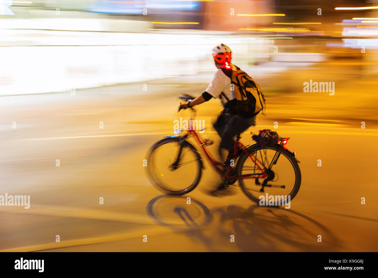picture with motion blur of a bicycle rider at night in the city Stock ...