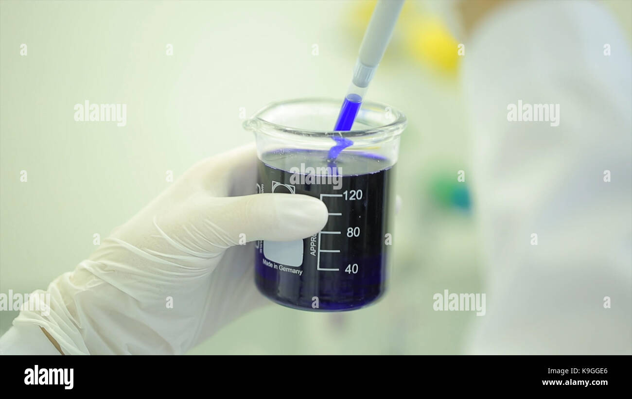 Test tubes closeup. Medical equipment. Close-up footage of a scientist using a micro pipette in a laboratory. Laboratory technician injecting liquid into a microtiter plate. Test tubes. Small depth of field. Stock Photo