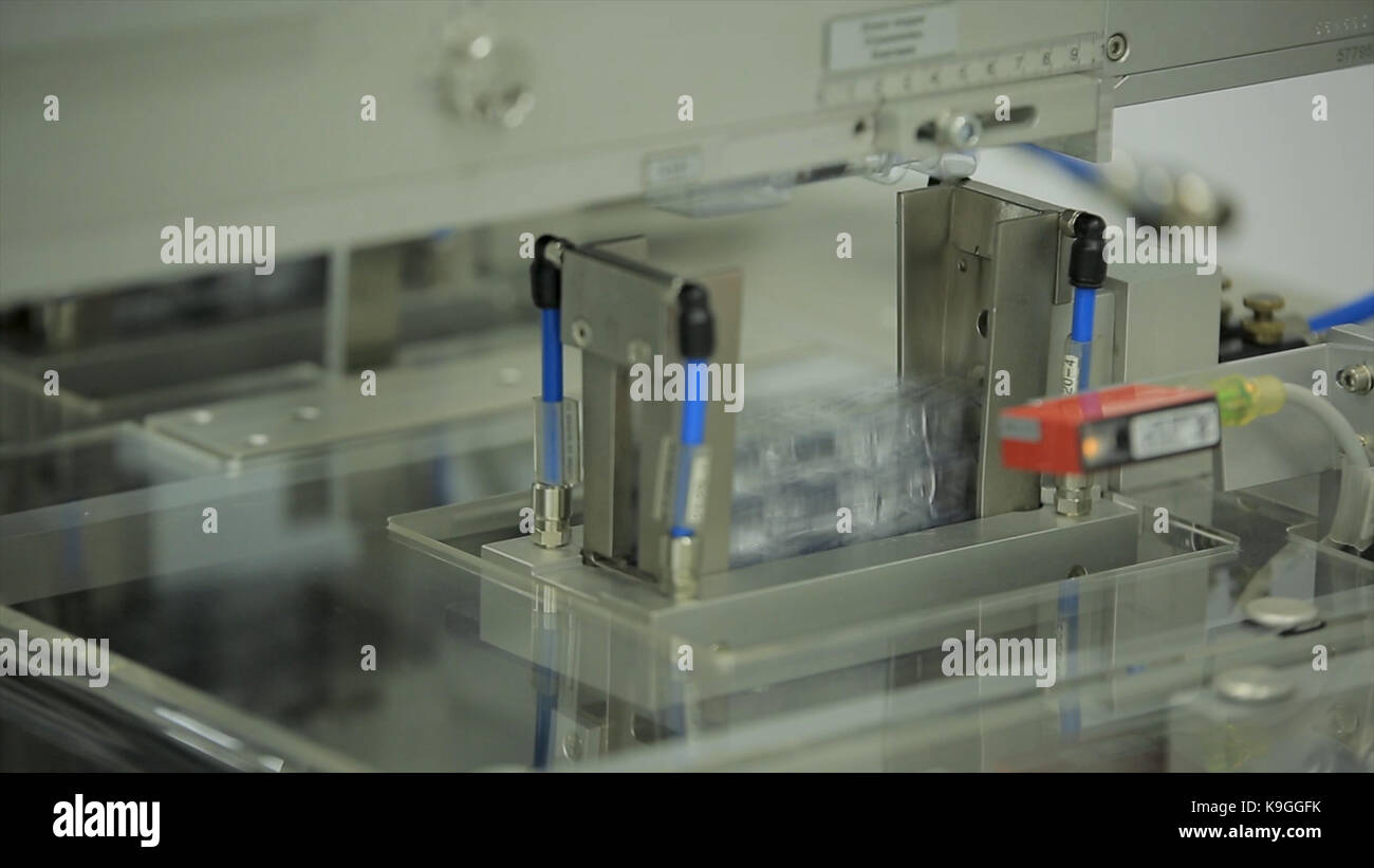 Pharmaceutics. Pharmaceutical worker operates tablet blister packaging