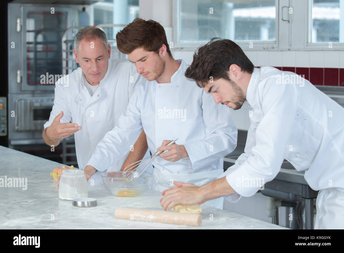 chef and trainees in restaurant kitchen Stock Photo - Alamy