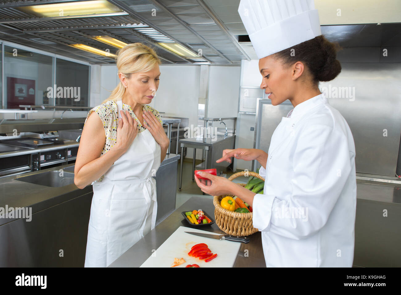 young cook trainee with experienced teacher cooking Stock Photo - Alamy