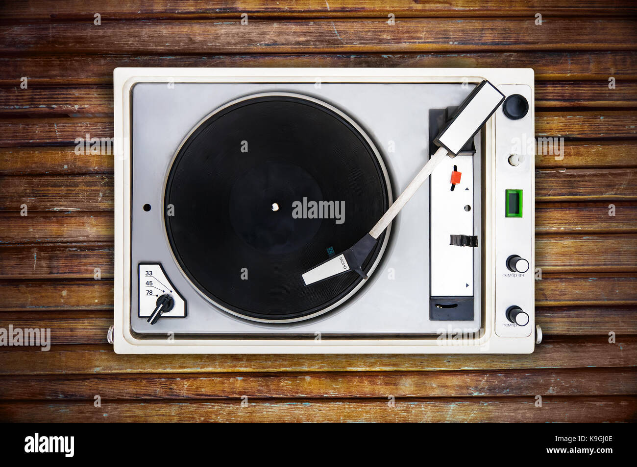 The old Soviet vinyl player isolated on wooden background. turntable Stock Photo