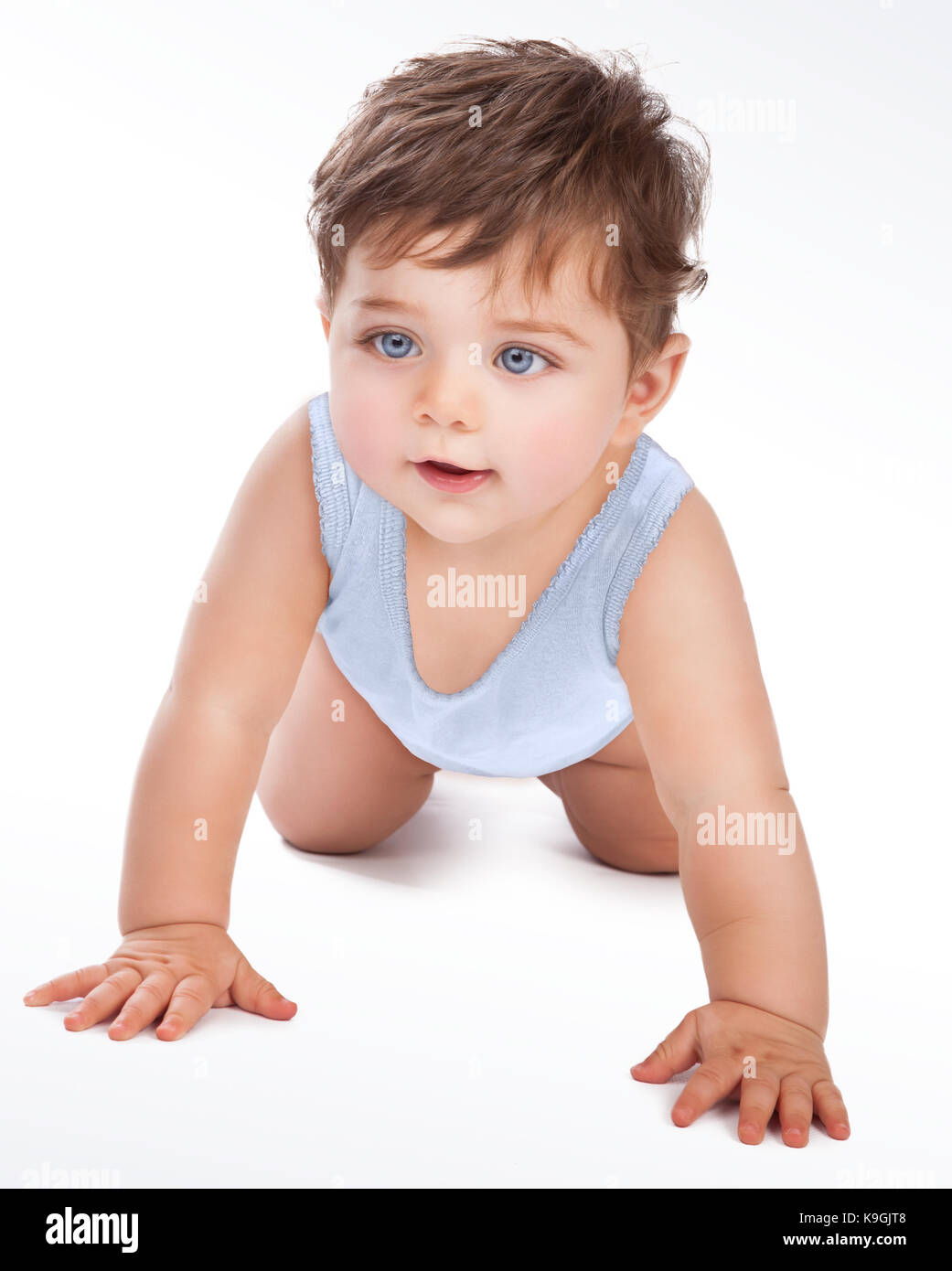 Cute little baby boy crawling in the studio isolated on white grey ...