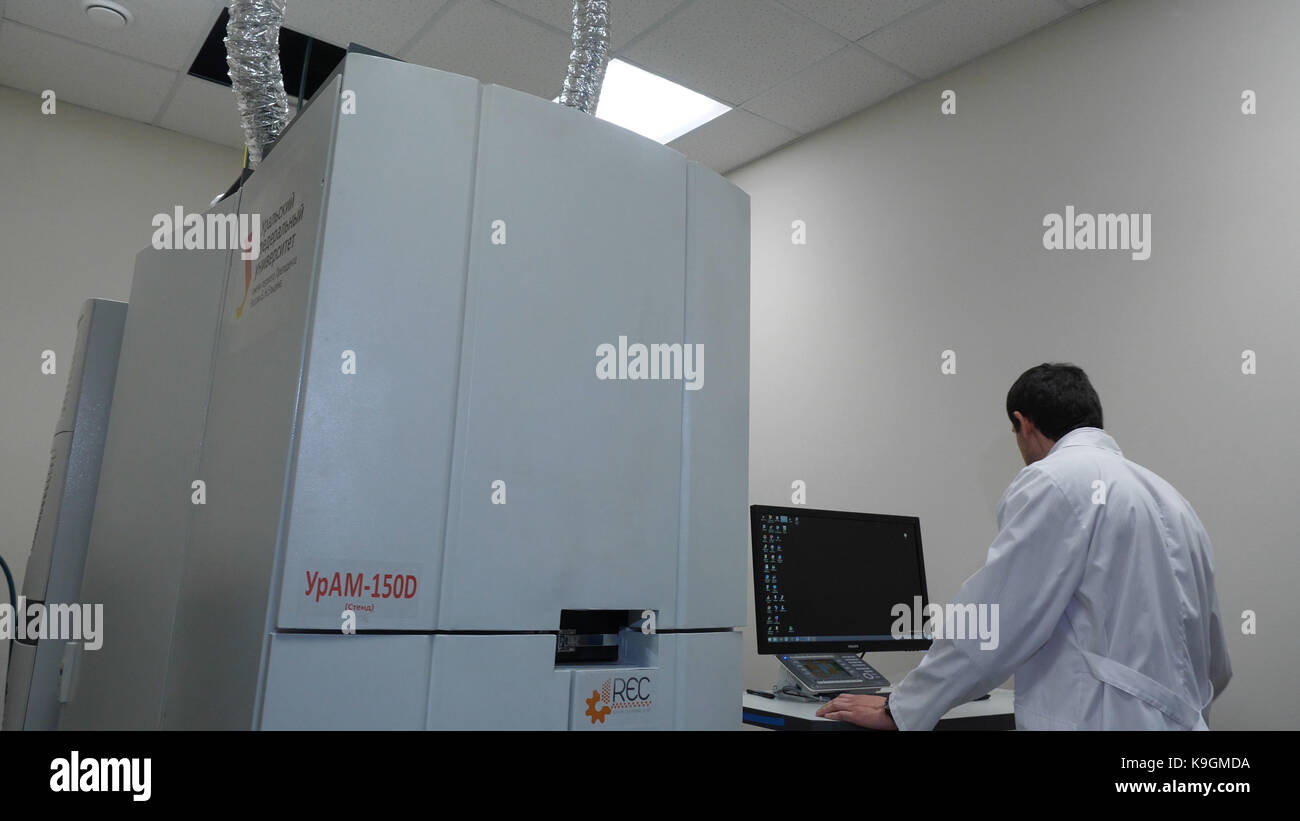 Senior researche rusing a computer in the lab while working on an ...