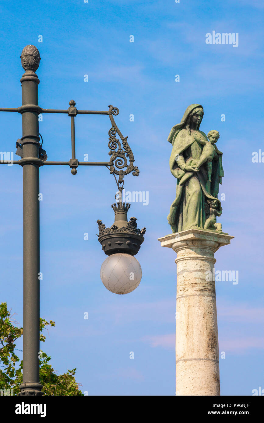 Valencia city symbol, view of a typical Valencian lamp post next to the Monumento Virgen del Carmen at the Plaza Portal Nuevo in Valencia, Spain. Stock Photo