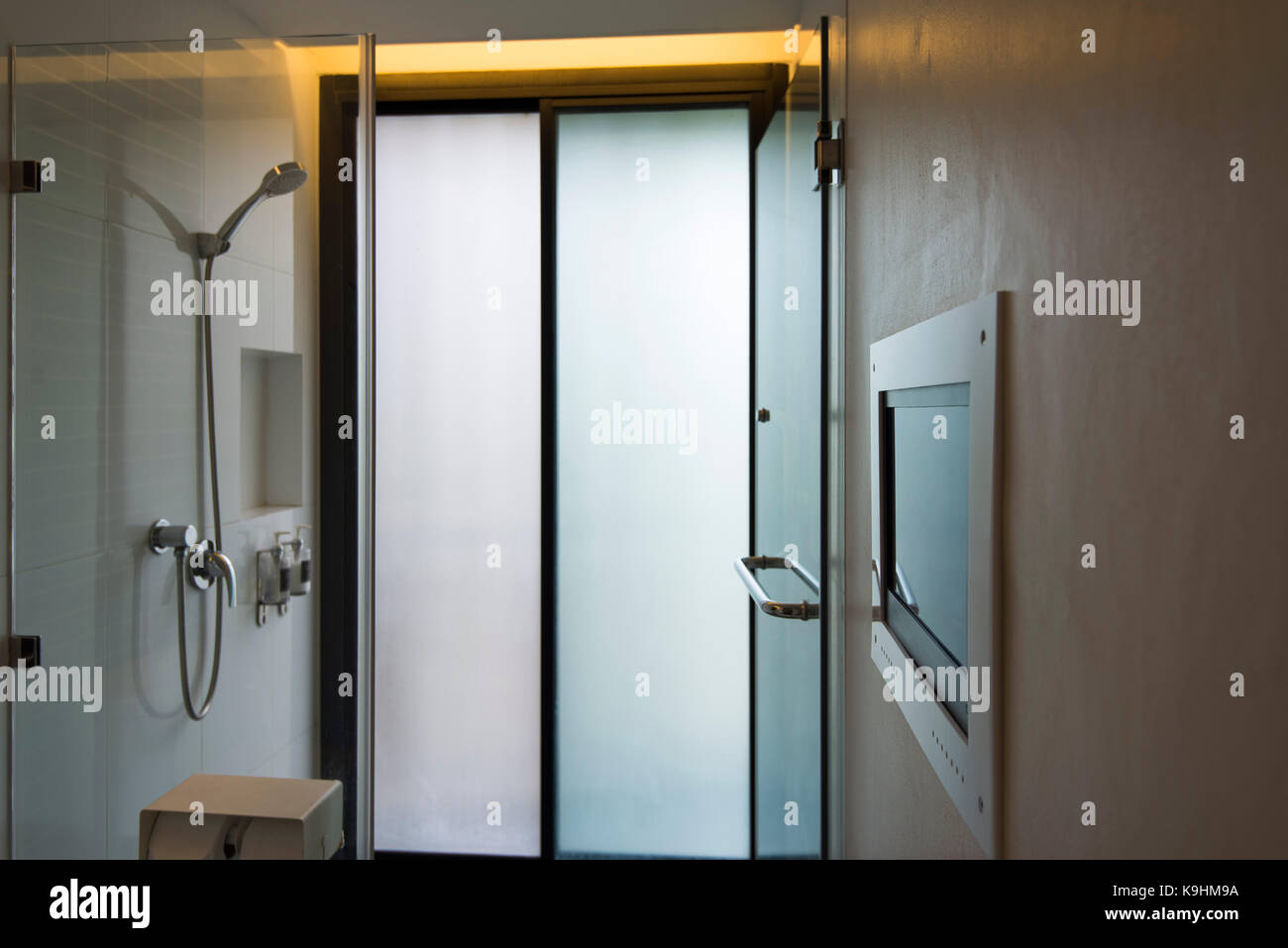 Modern bathroom with Television screen for entertainment while using the toilet and bathroom. Stock Photo