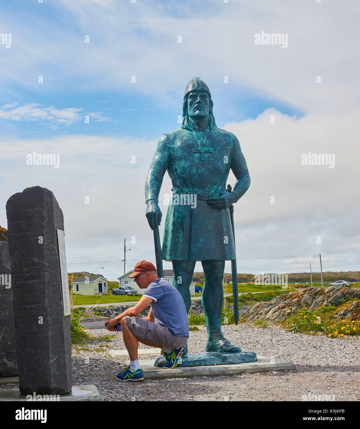 Middle aged male Swedish tourist at Leif Erikson statue, L'Anse Aux Meadows, Newfoundland, Canada. Stock Photo