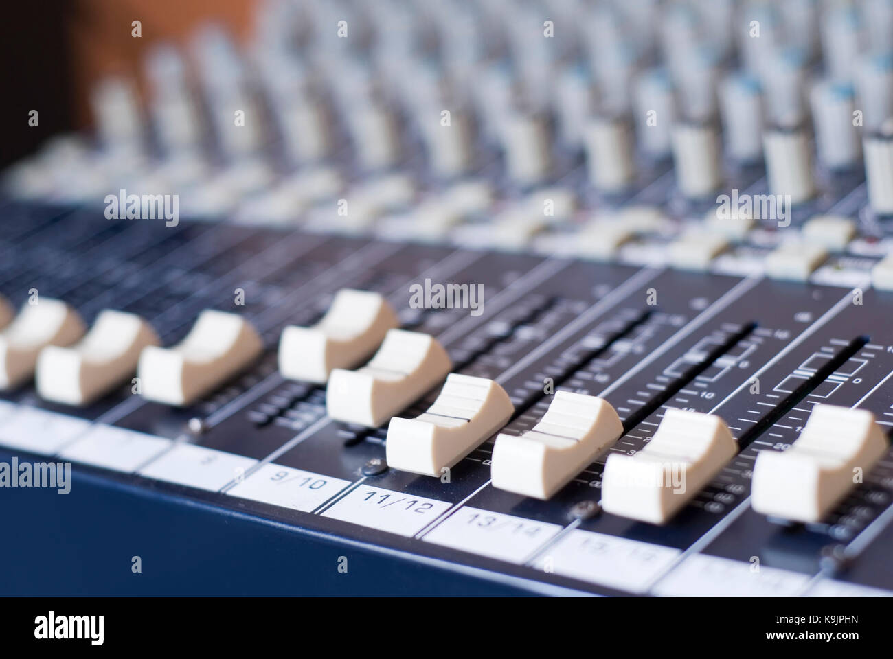 Many knobs controllers and switches on a audio mixer Stock Photo