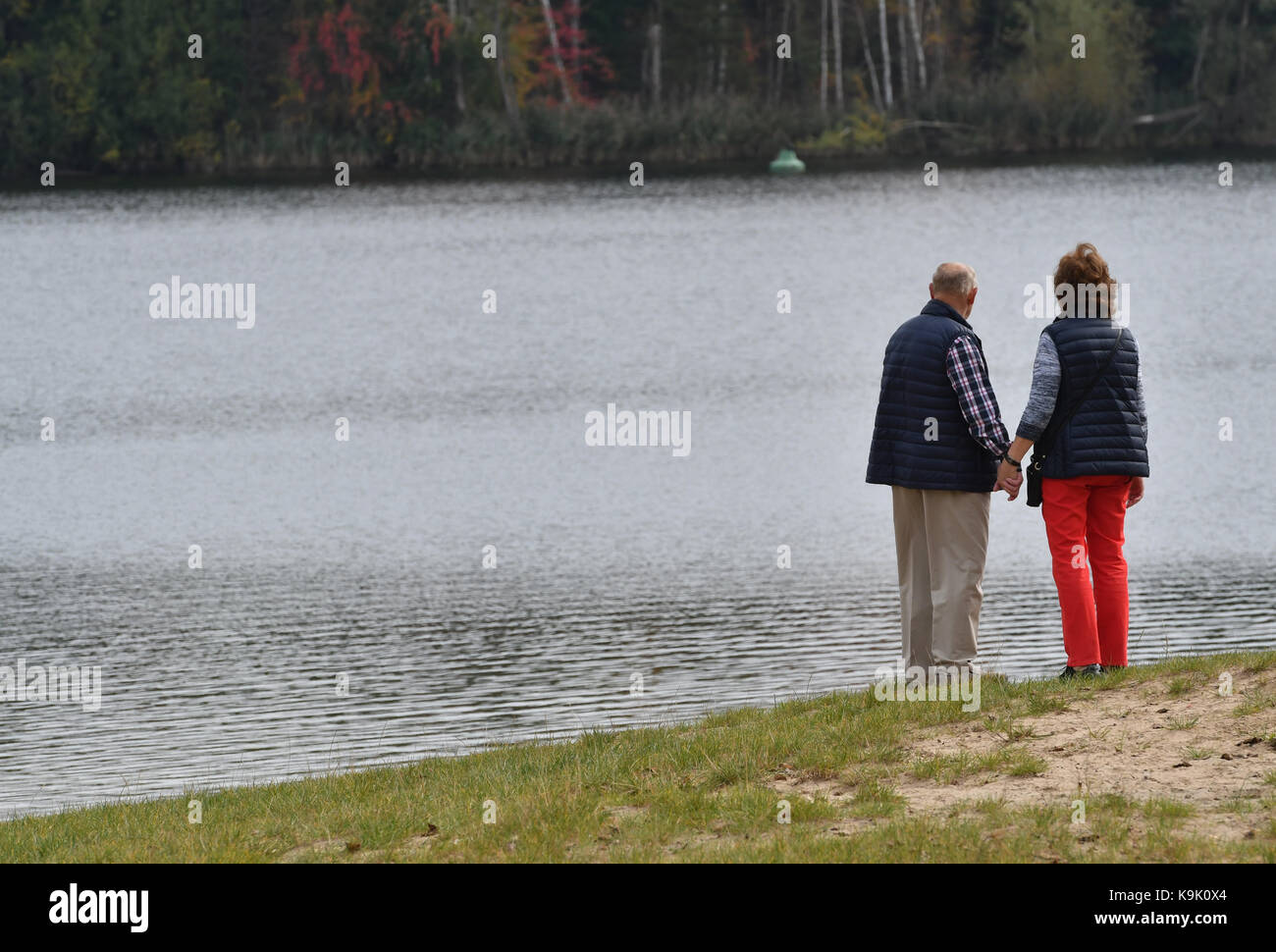 Berlin, Germany. 23rd Sep, 2017. A man and a woman stand on the shores of the Flughafen Lake in Berlin, Germany, 23 September 2017. Credit: Paul Zinken/dpa/Alamy Live News Stock Photo
