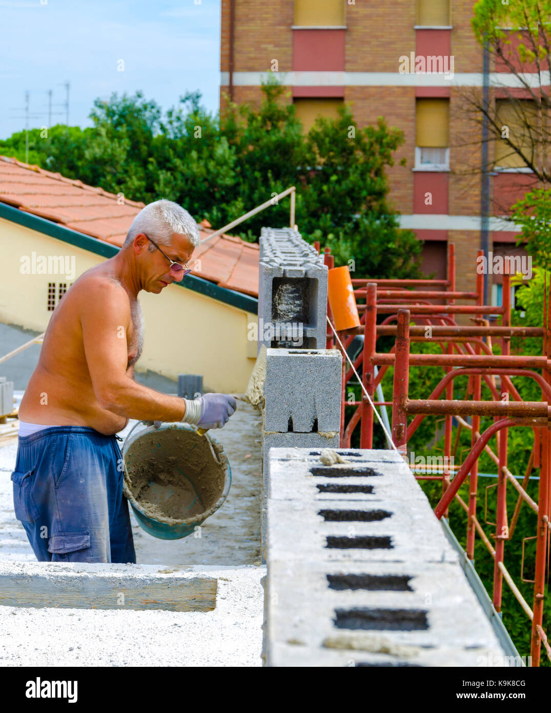 Red cement mix and trowel on the construction site Stock Photo - Alamy