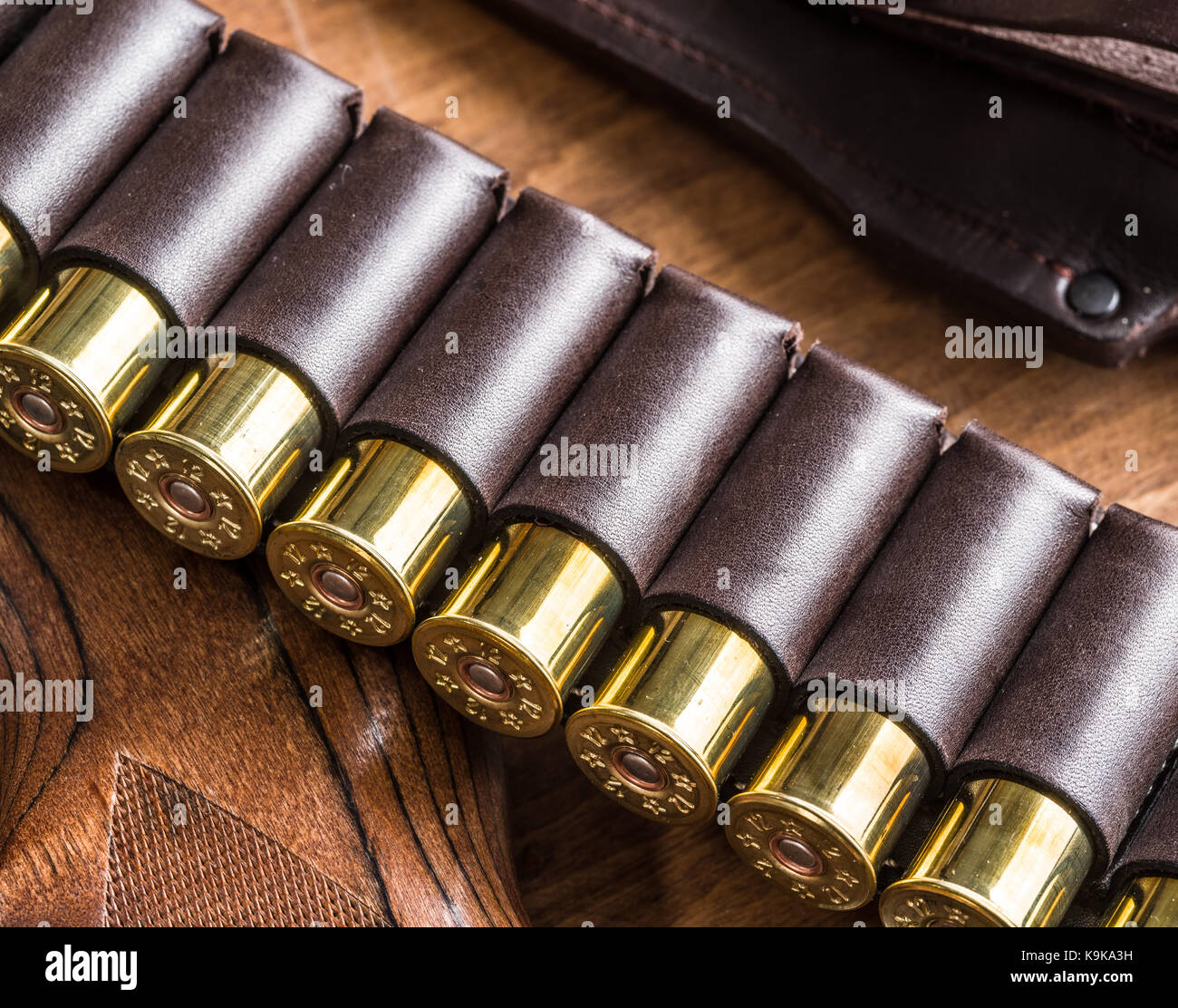 Hunting equipment - pump action shotgun, 12 guage cartridge and hunting  knife on the wooden table Stock Photo - Alamy