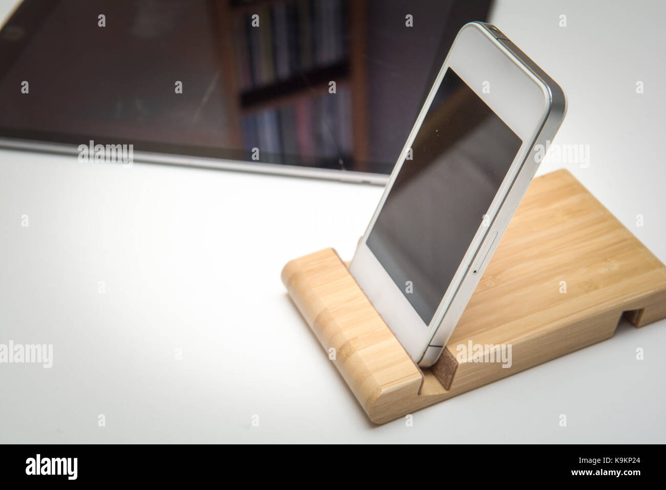 smart phone and tablet wireless charging on a white desk Stock Photo