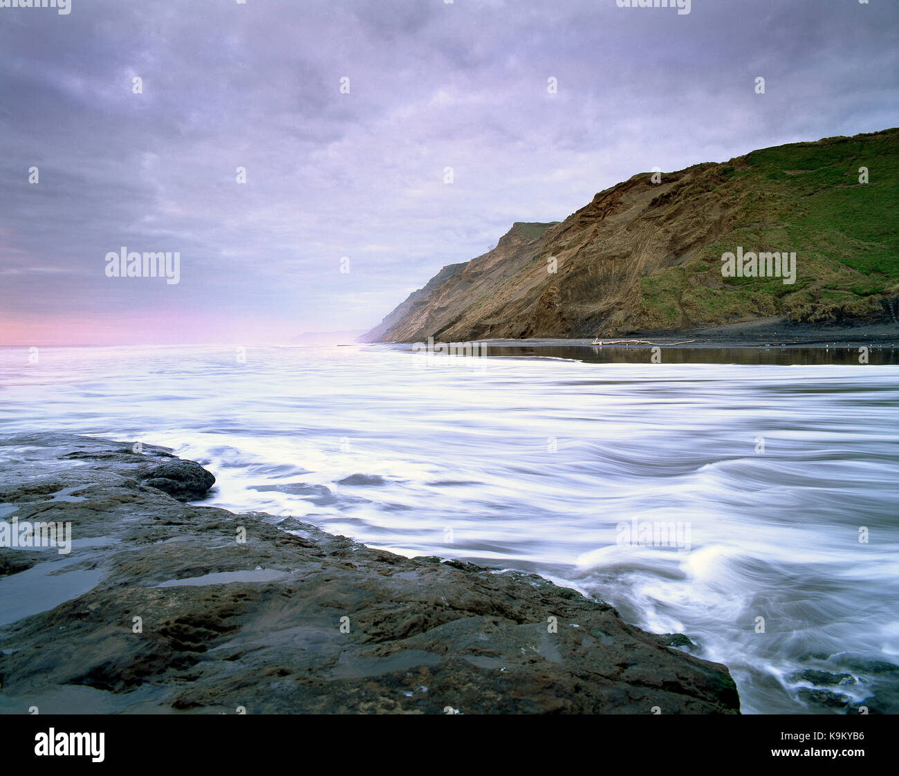 New Zealand. North Island. Auckland Region. West coast cliffs and tidal surge. Stock Photo
