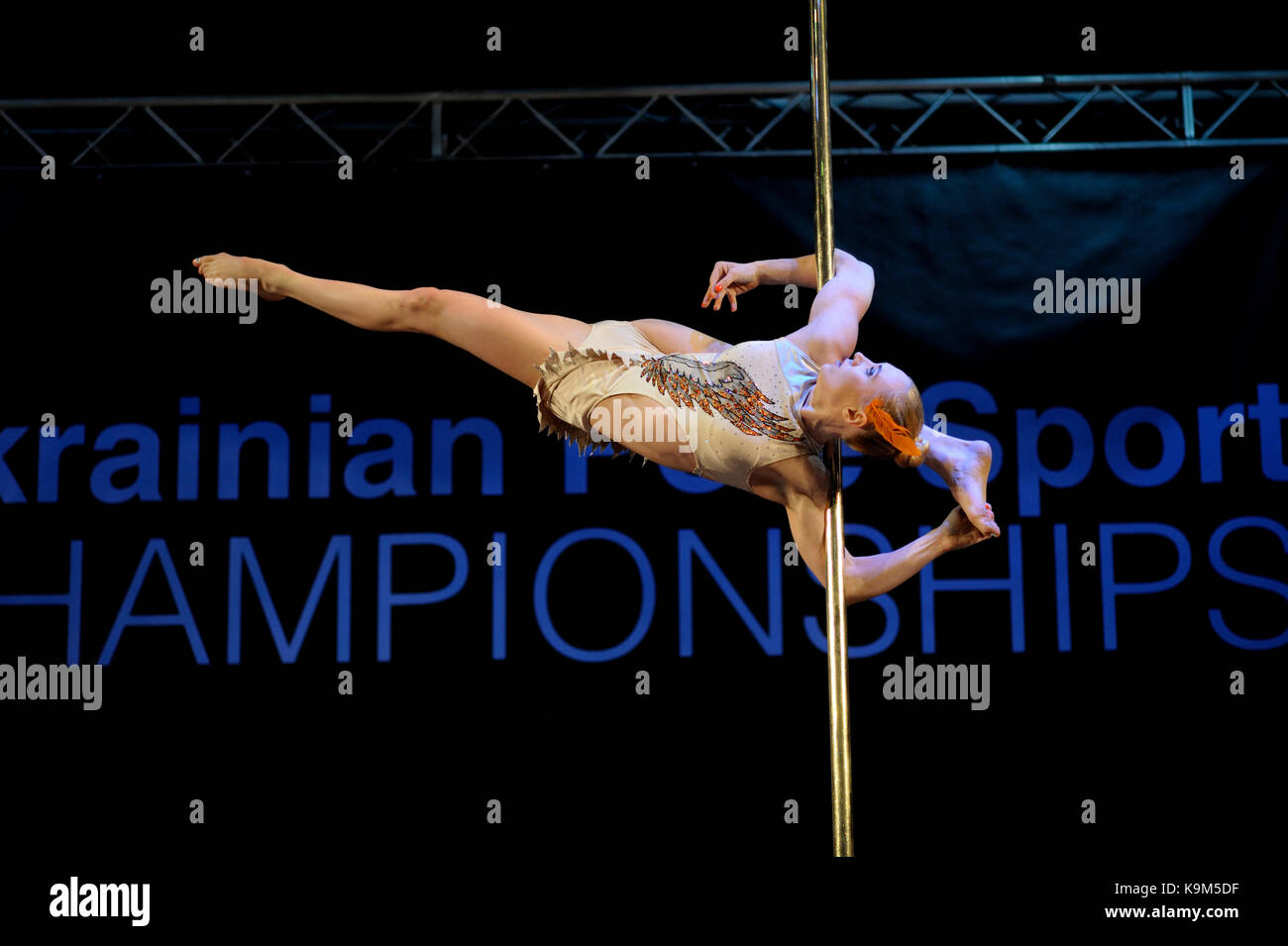 Young woman athlete performing on a pole. Ukrainian Pole Dance Championship  March 26, 2016 Stock Photo - Alamy