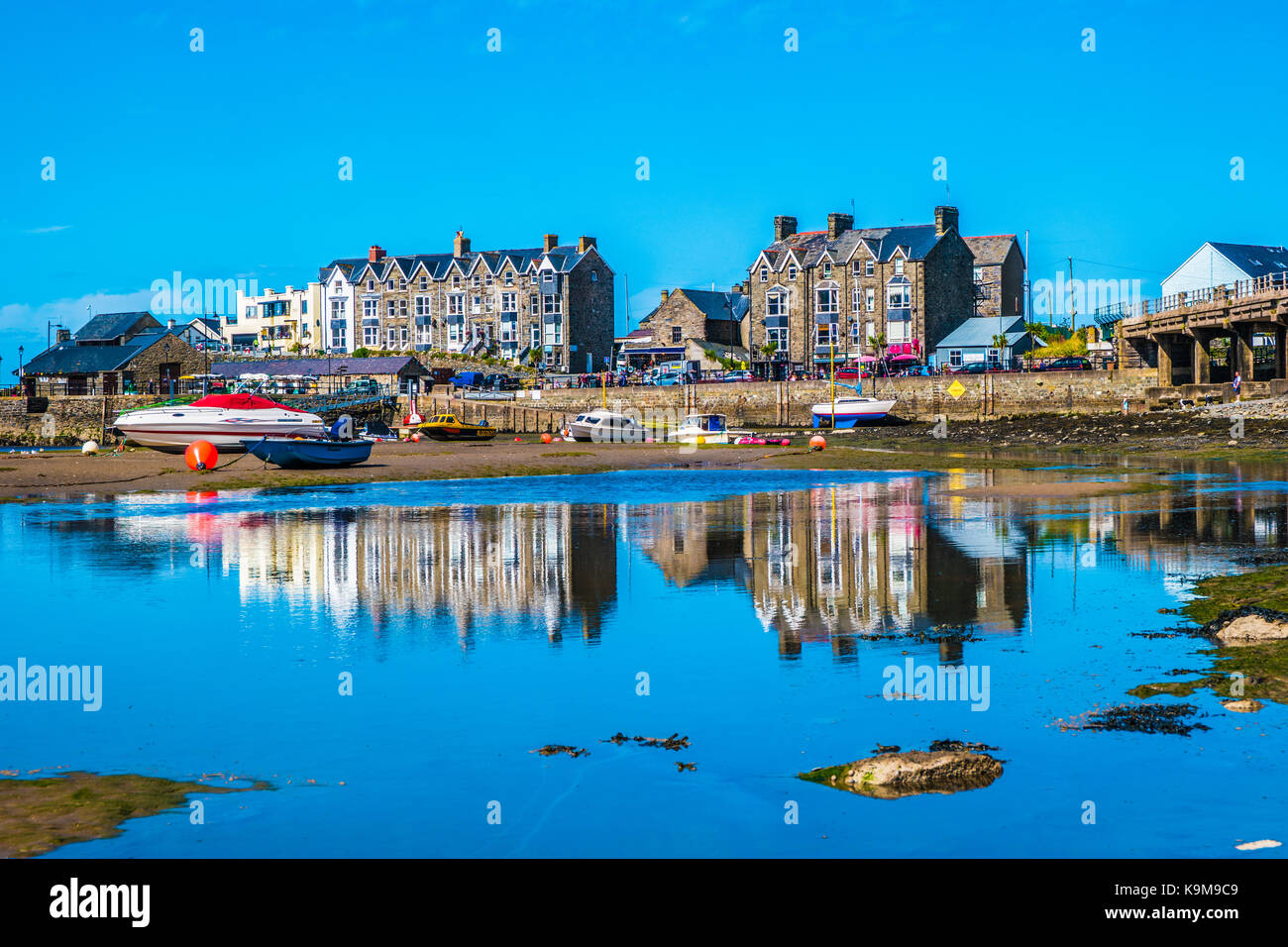 Barmouth harbour at low tide with reflections. Stock Photo