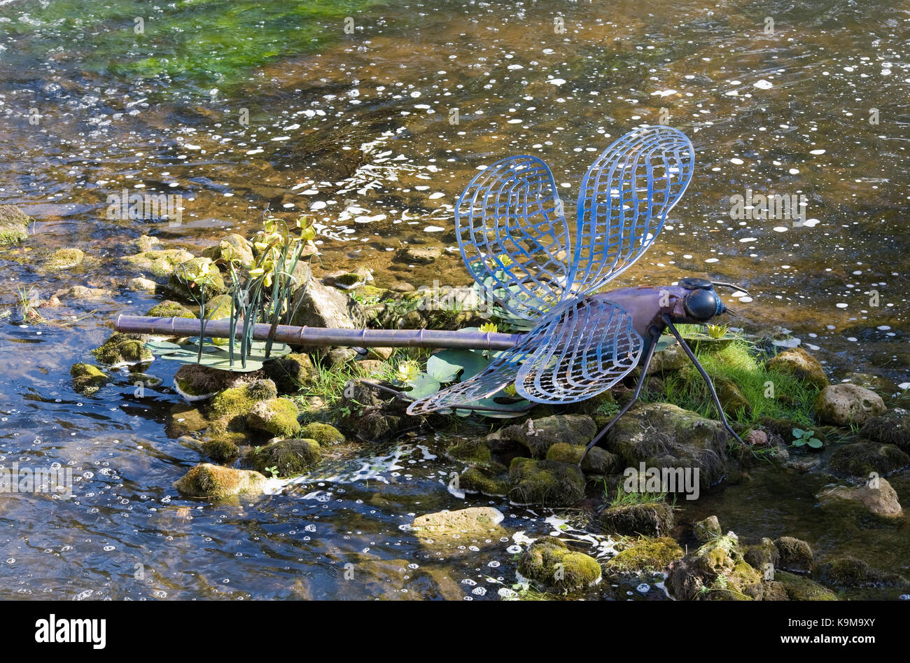 Metal dragonfly sculpture on the River Dronne at Brantome, France. Stock Photo
