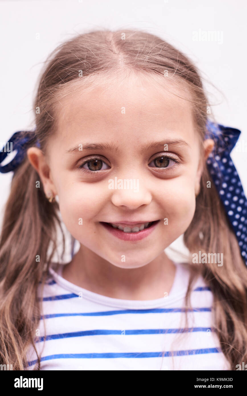 Portrait of smiling little girl with braids Stock Photo - Alamy