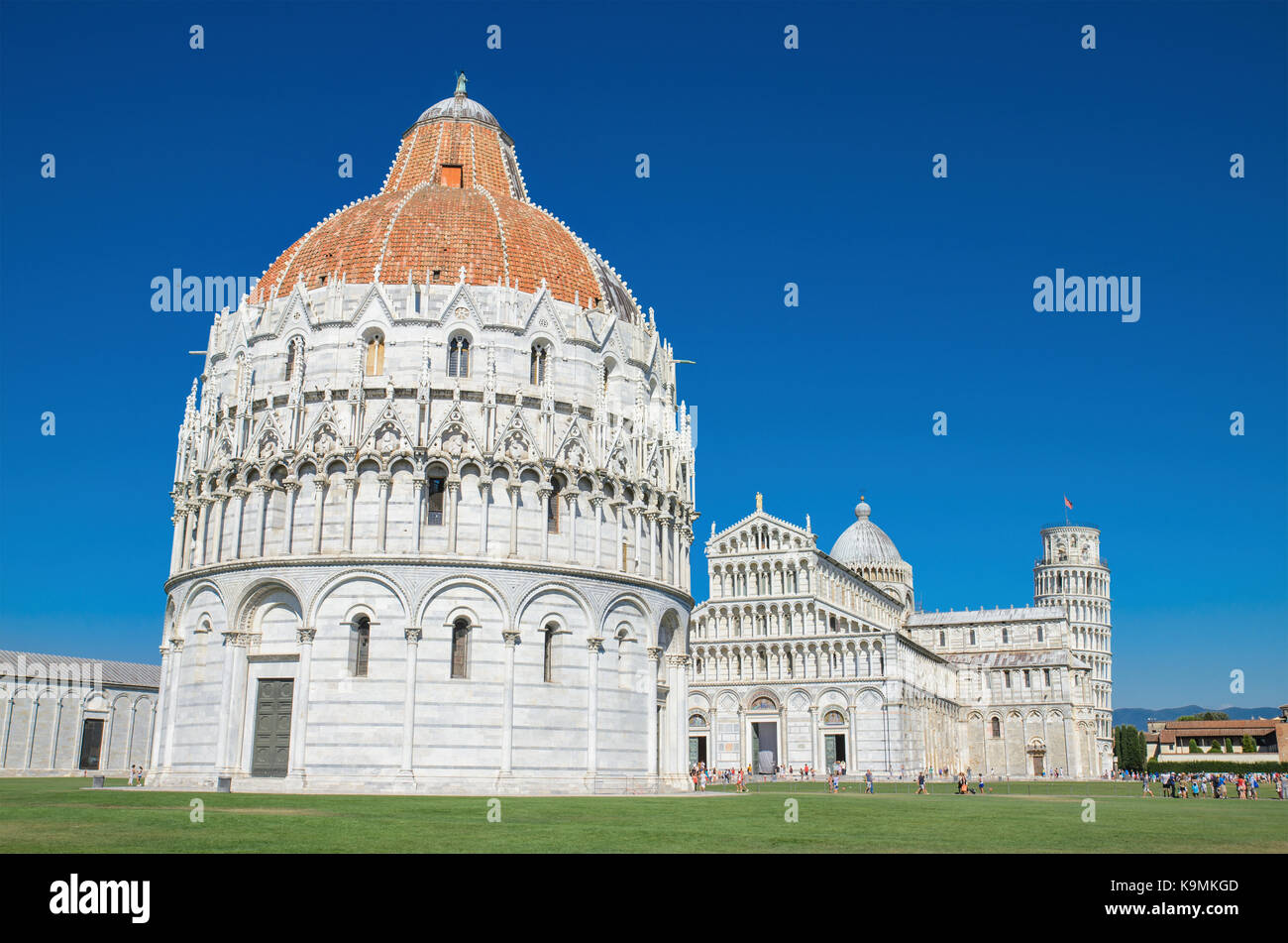 Baptistery and Pisa Tower view from miracle square. Pisa, Italy. Stock Photo