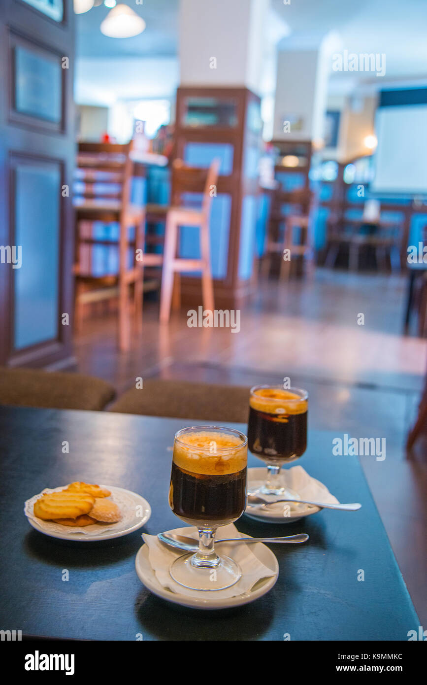 Two Irish coffees and biscuits in a traditional cafe. Madrid, Spain. Stock Photo