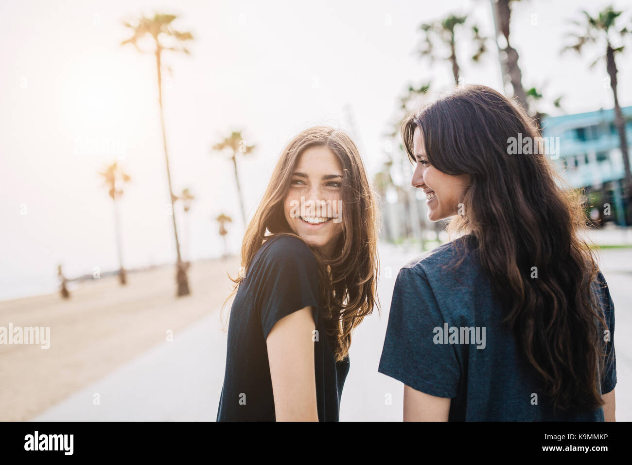 Two happy young women on boardwalk Stock Photo - Alamy