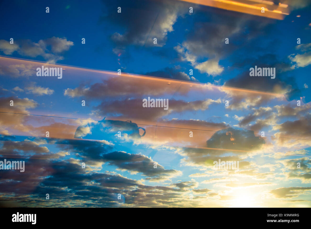 Sunrise sky viewed through a window. Stock Photo