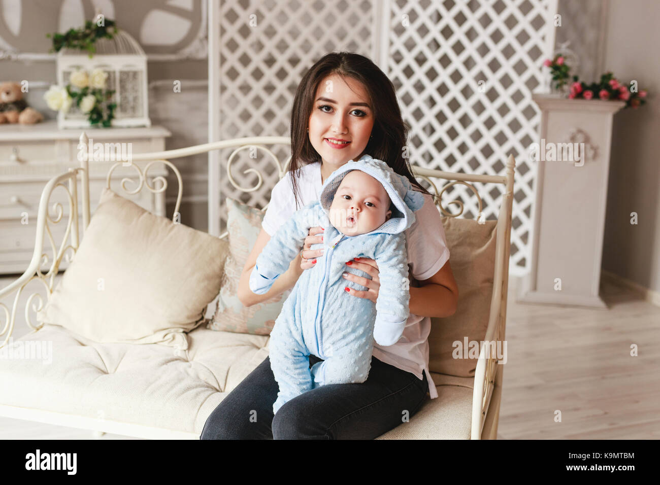 Newborn mixed race baby boy and his young mother. Asian and British new born baby. Stock Photo