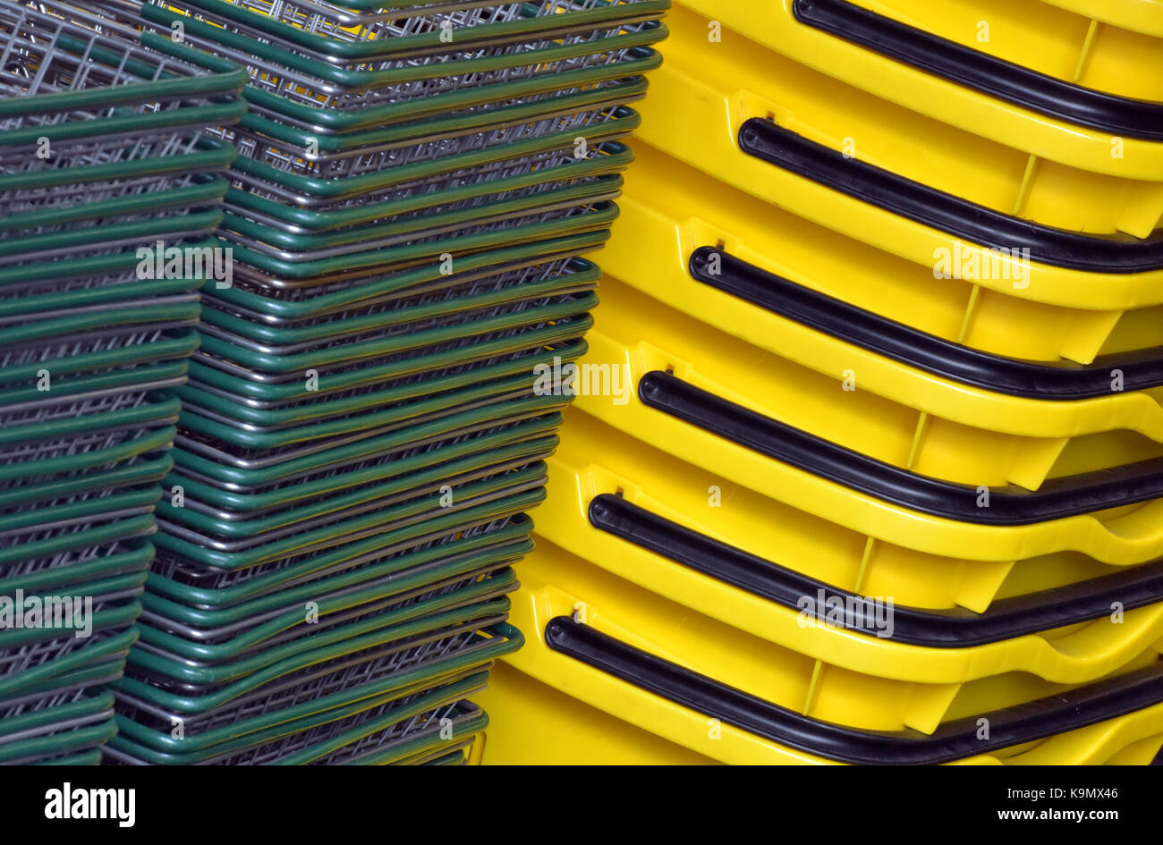 shopping baskets stacked up in a supermarket or retail outlet ready for