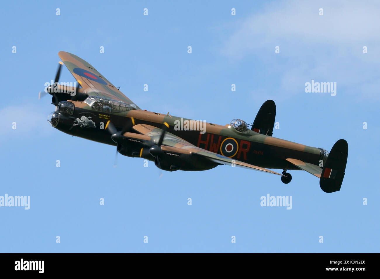 PA474, the Battle of Britain Memorial Flight's Avro Lancaster banking around then top corner of the crowd line at a Rougham Airshow. Stock Photo