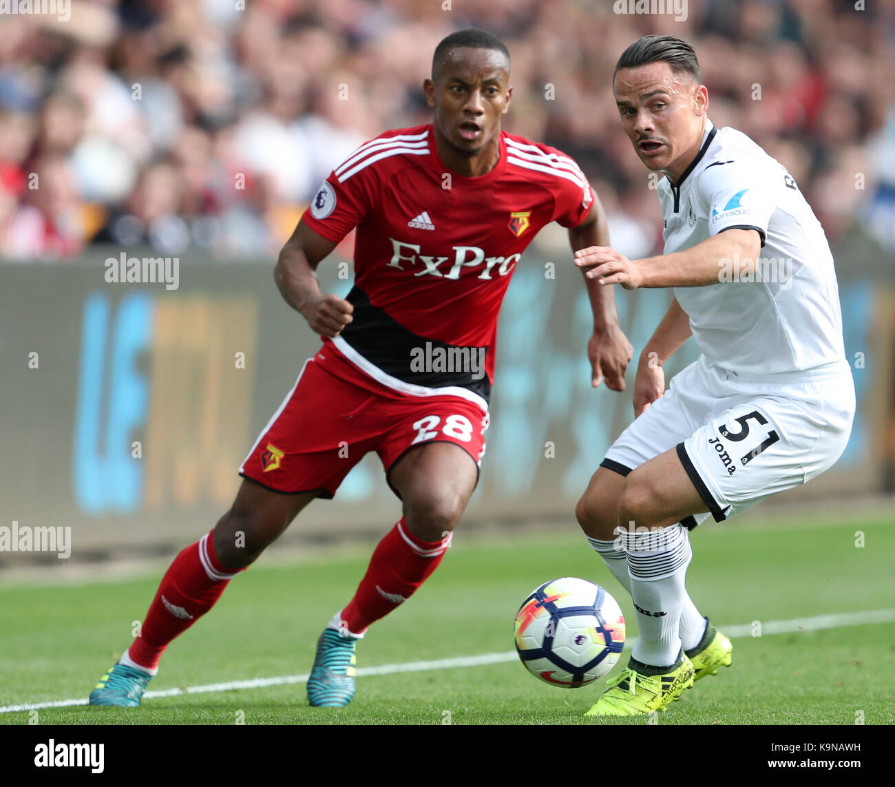 Watford's Andre Carrillo (left) and Swansea City's Roque Mesa during the Premier League match at the Liberty Stadium, Swansea. Stock Photo