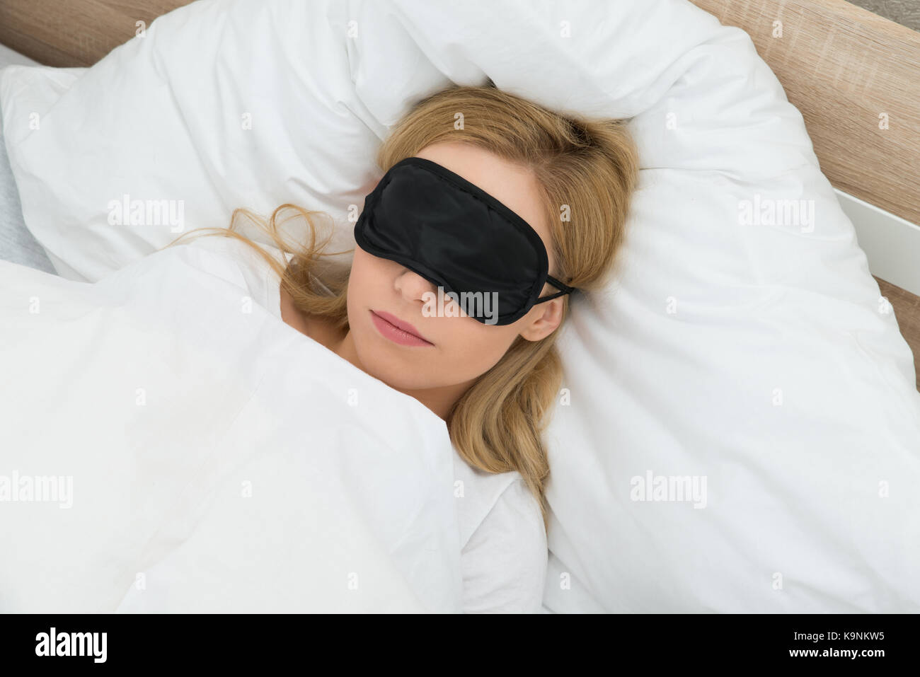 Young Woman Sleeping With Sleep Mask In Bedroom Stock Photo Alamy