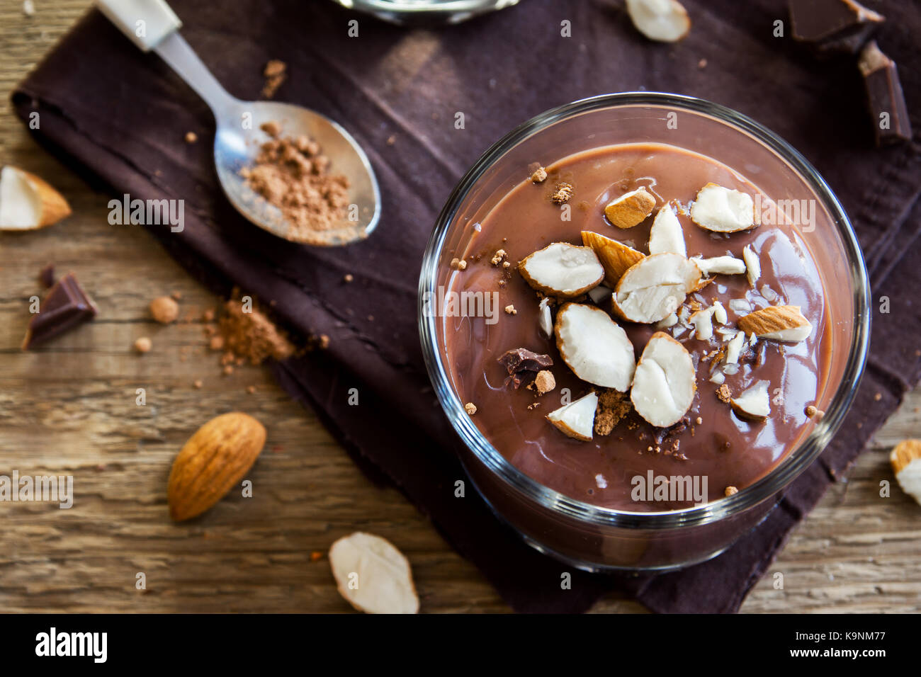 Chocolate Mousse topped with Almond in glasses over wooden background