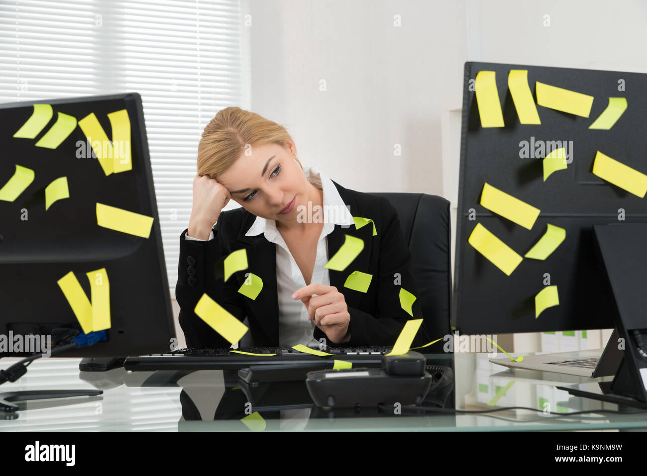 Tired Businesswoman With Adhesive Notes Sitting In Office Stock Photo ...