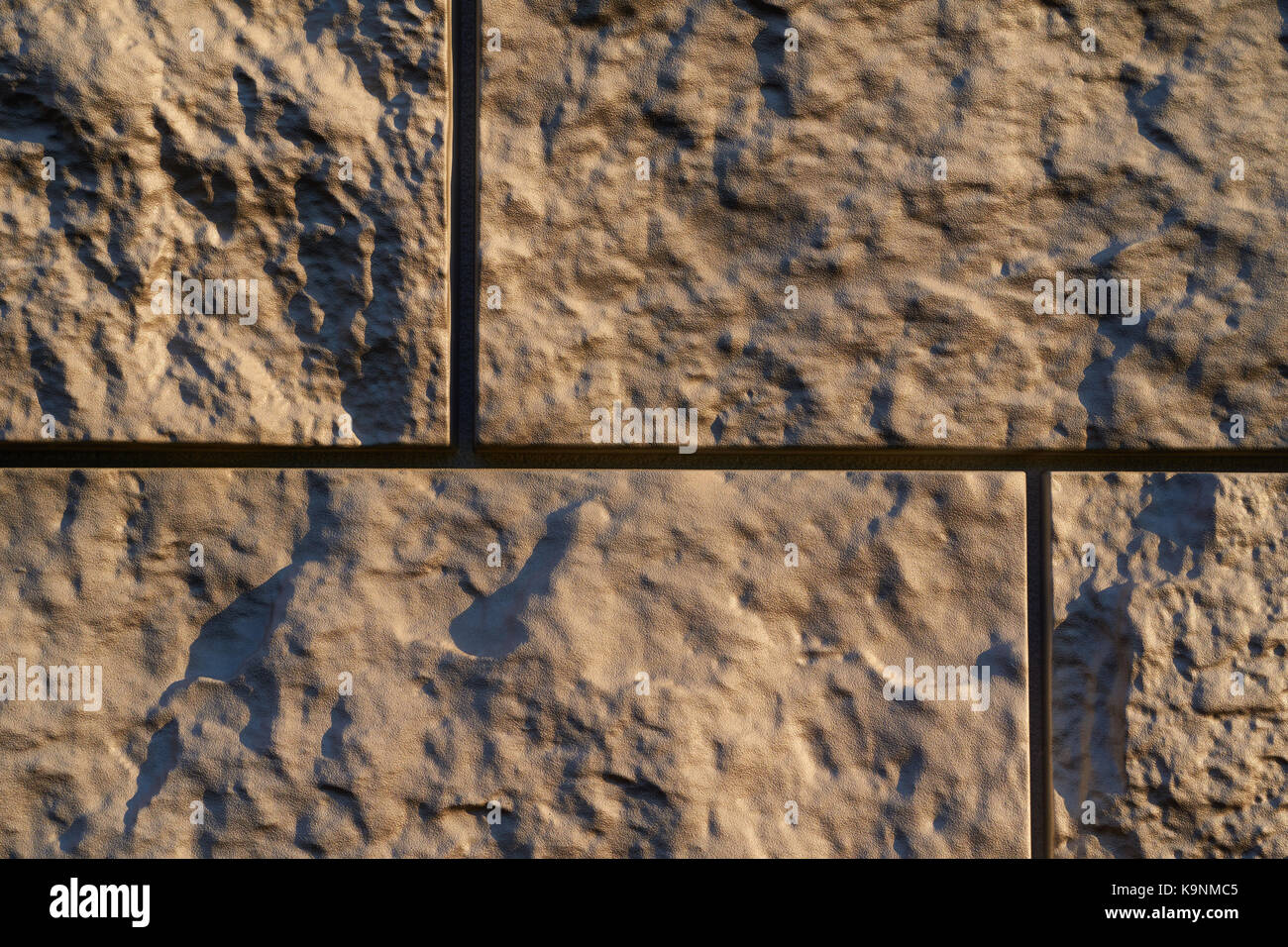 Artificial stone textured finishing on the foundation of the house ...