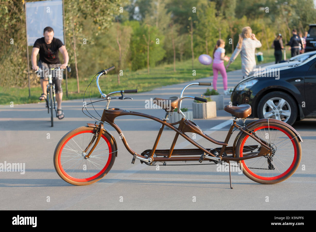 A chocolate-colored tandem bicycle with 