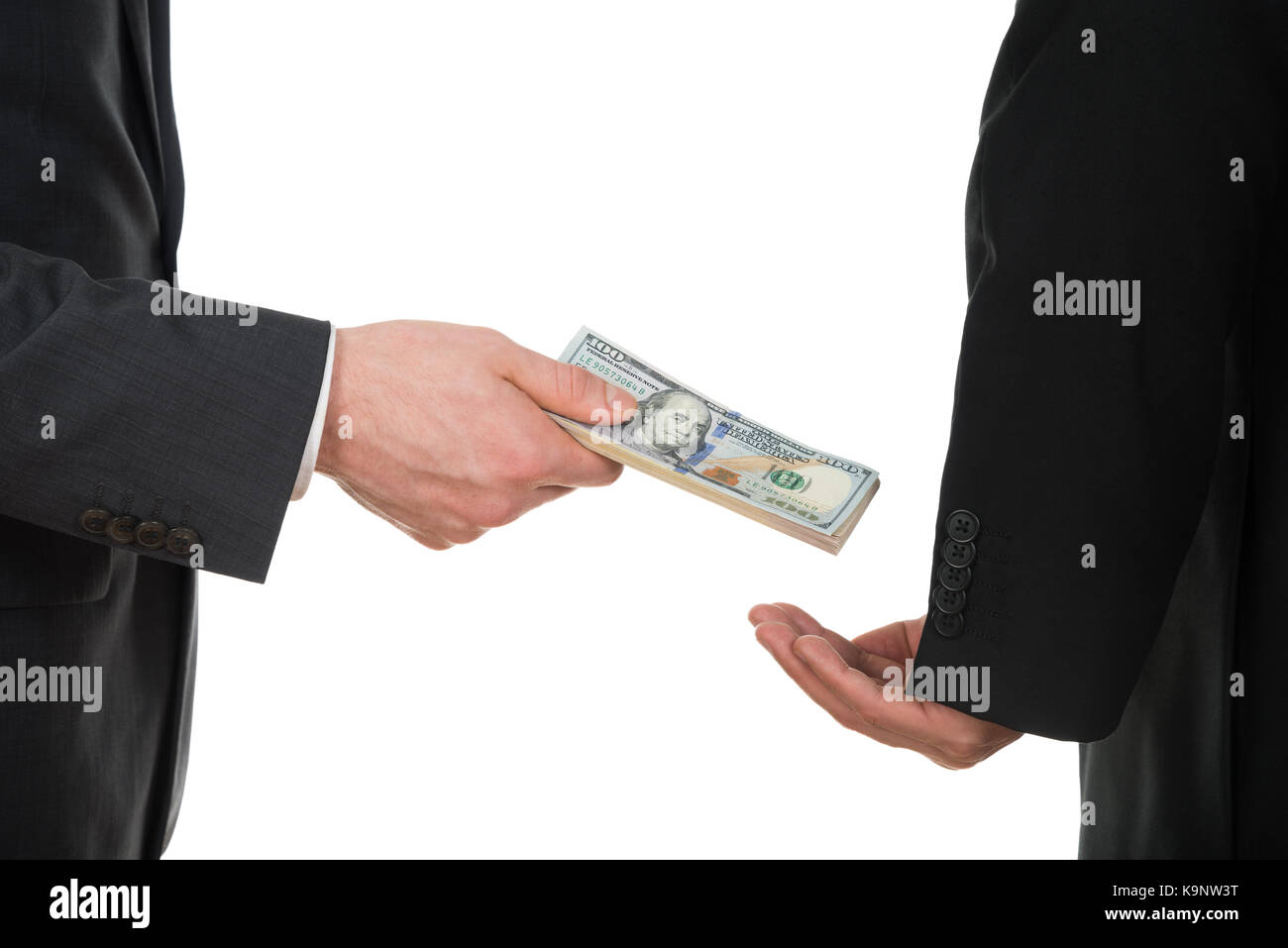 Close-up Of A Businessman Taking Bribe Over White Background Stock Photo