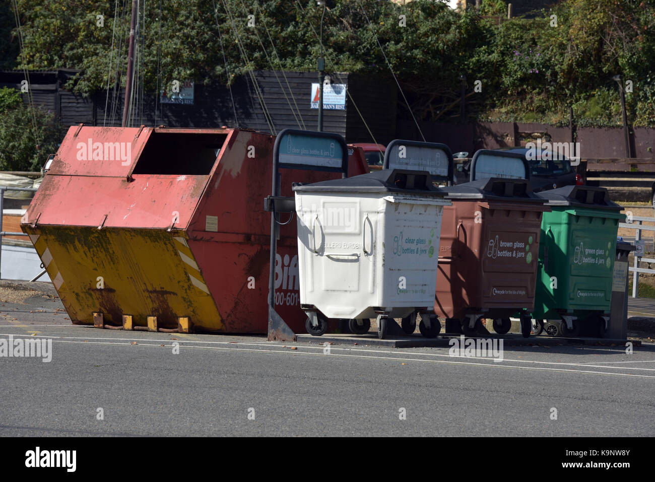 a rubbish skip and different recycling bins for glass, cardboard and