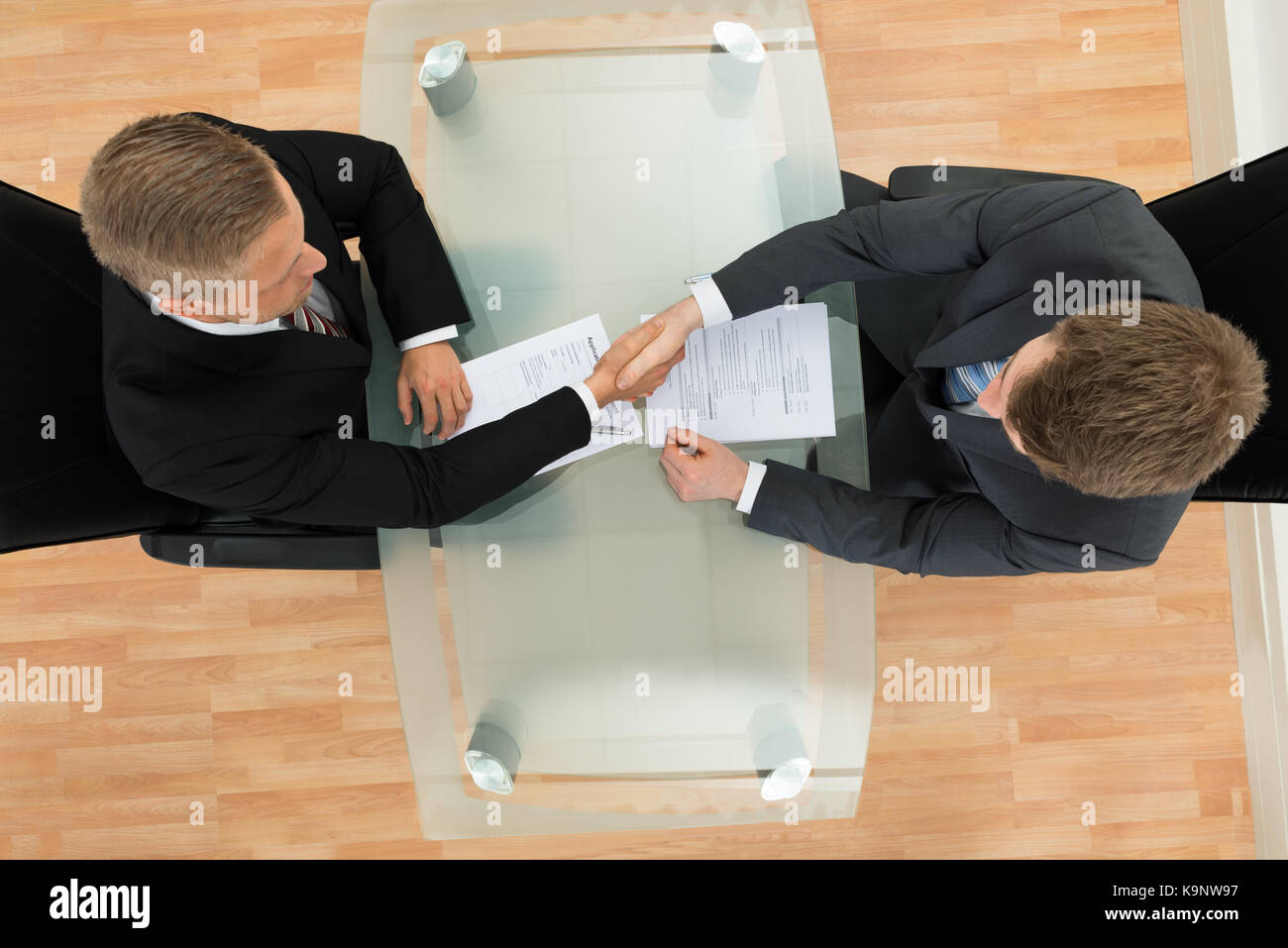 Elevated View Of Two Businessman Shaking Hands In The Office Stock Photo