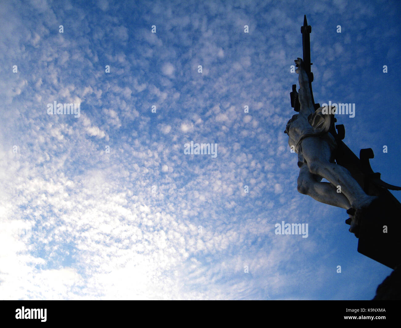 Statue of Jesus Christ on the cross and blue sky above Stock Photo - Alamy