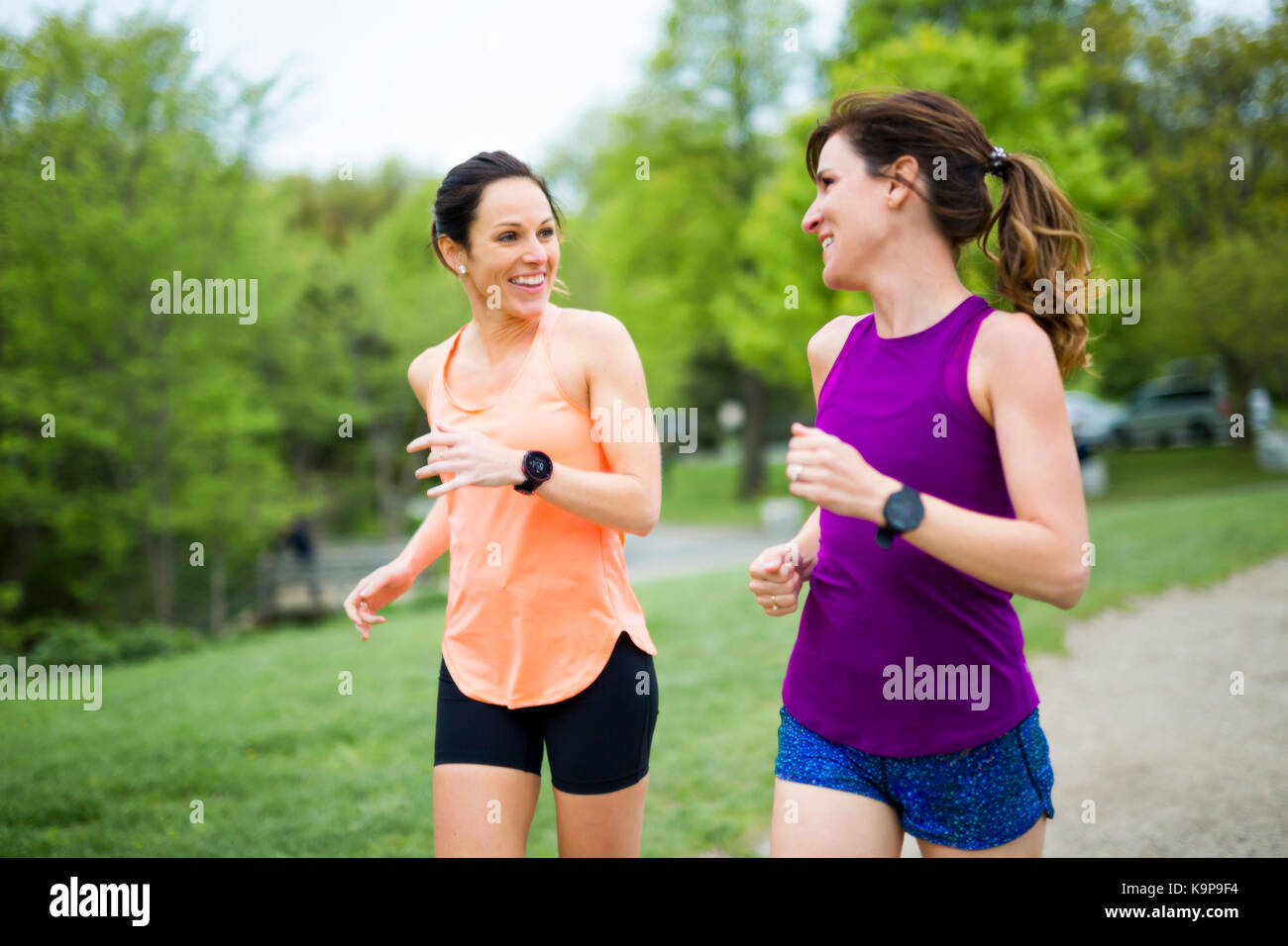 Two Beautiful Female runner outside having fun Stock Photo - Alamy