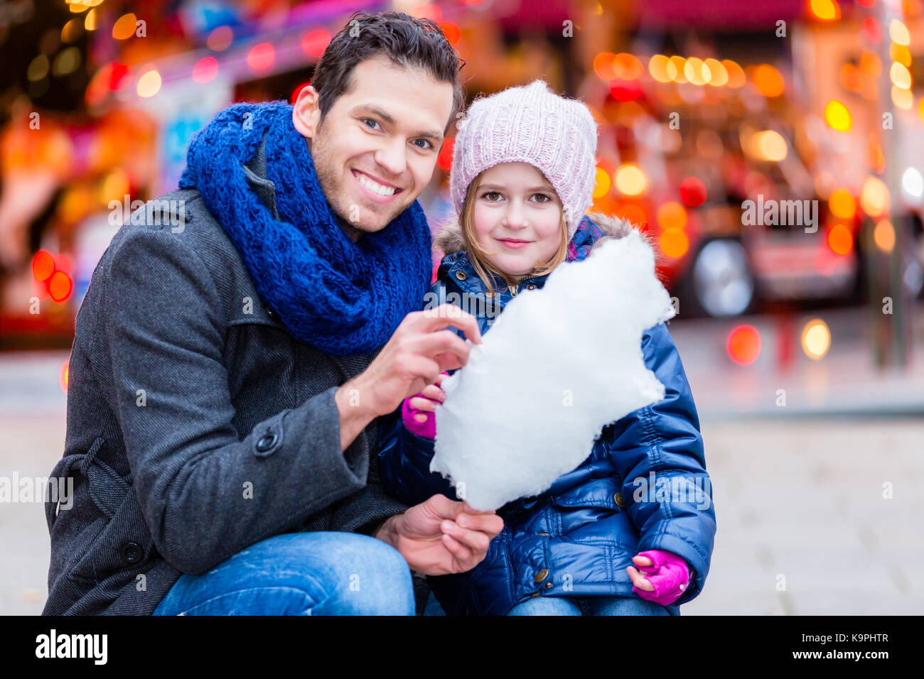 Father on Christmas market buying sweets for child Stock Photo