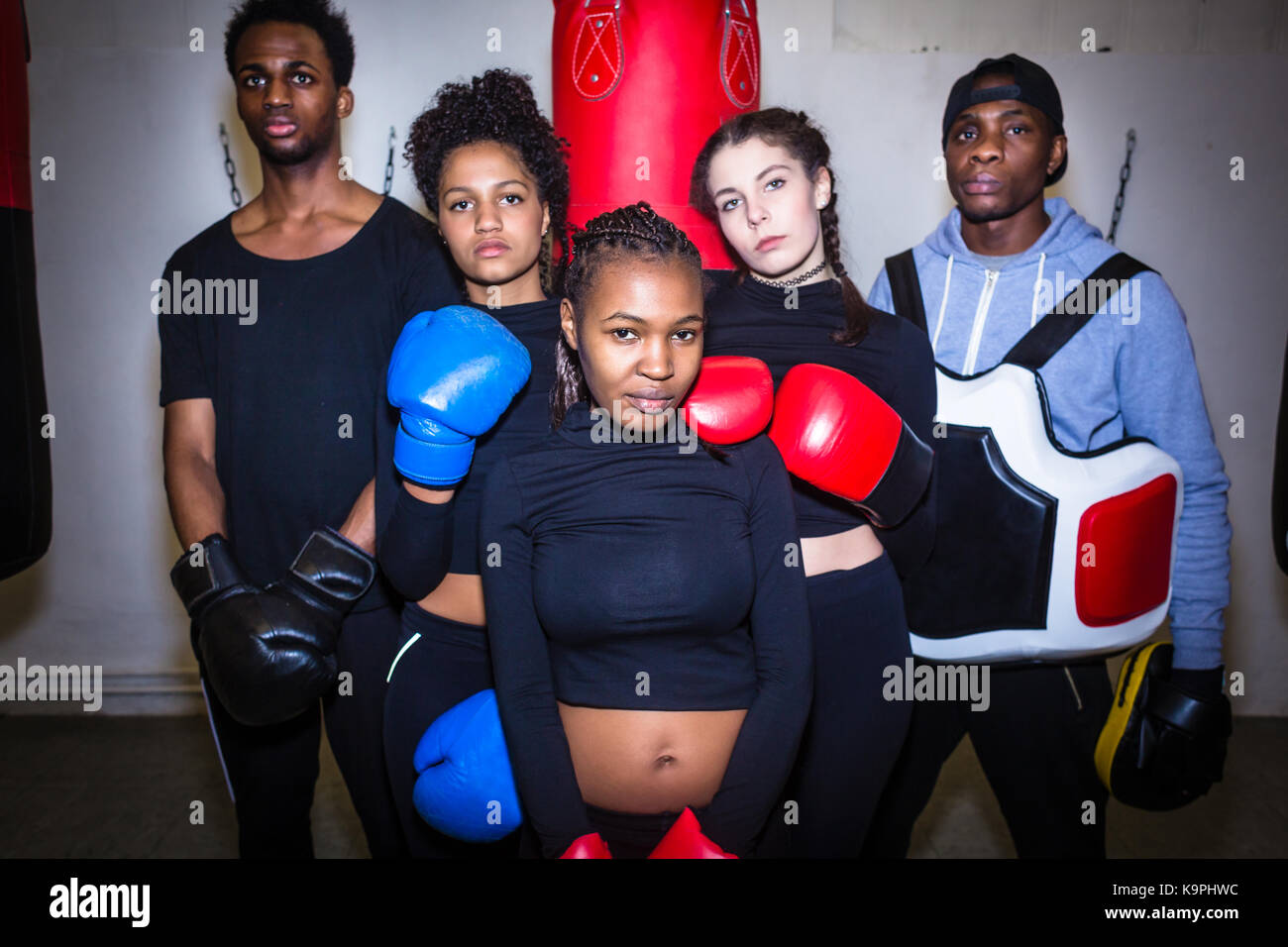 Portrait of four young determined boxers and their experienced b Stock ...