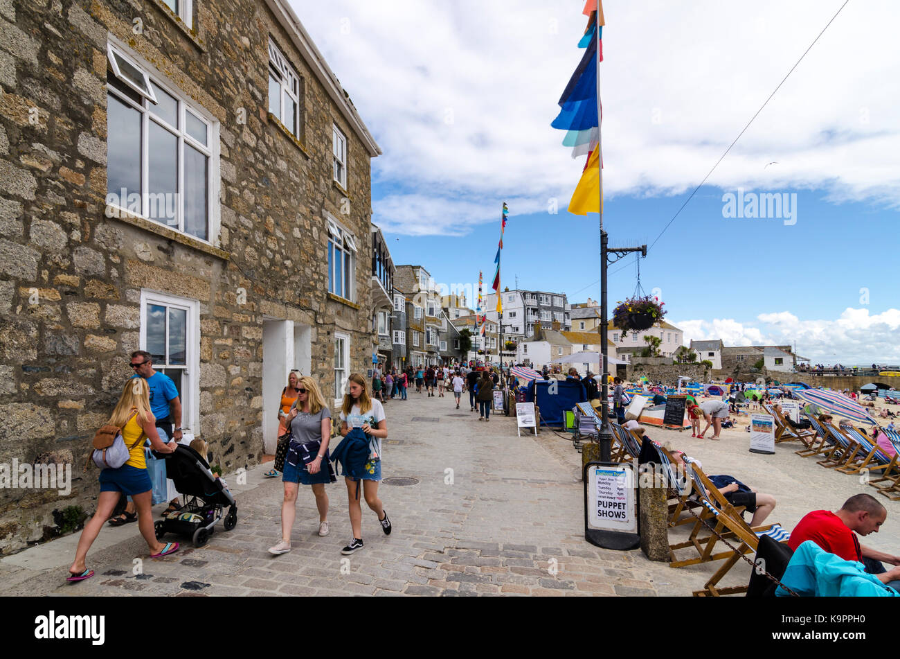 People and tourists walking along the sea front in St ives, Cornwall, England, UK Stock Photo