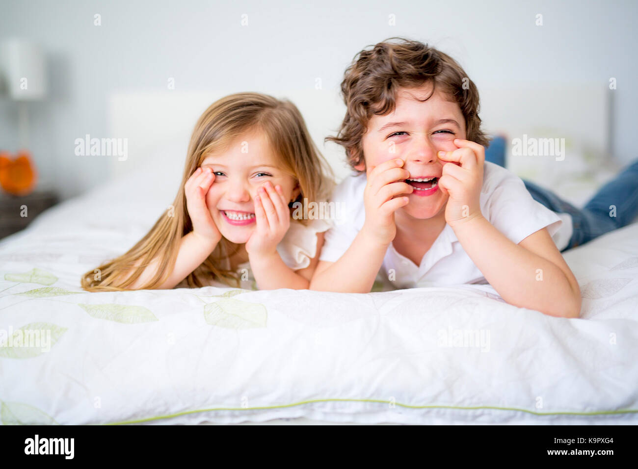 A Brother And Sister Relaxing Together In Bed Stock Photo - Alamy