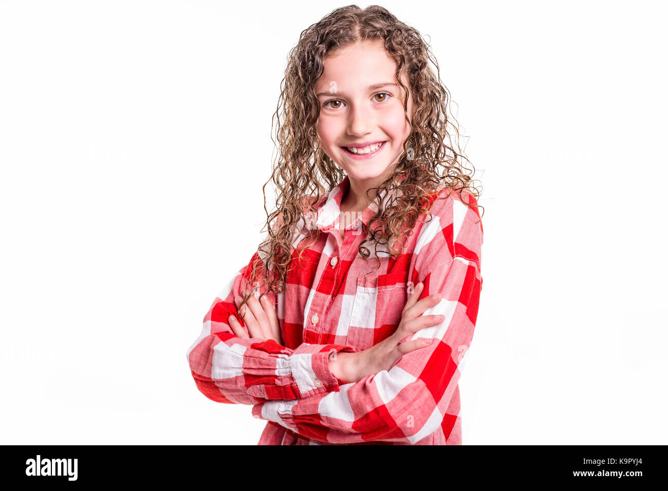 A Portrait of 9 years old girl with curly hair, isolated on white Stock