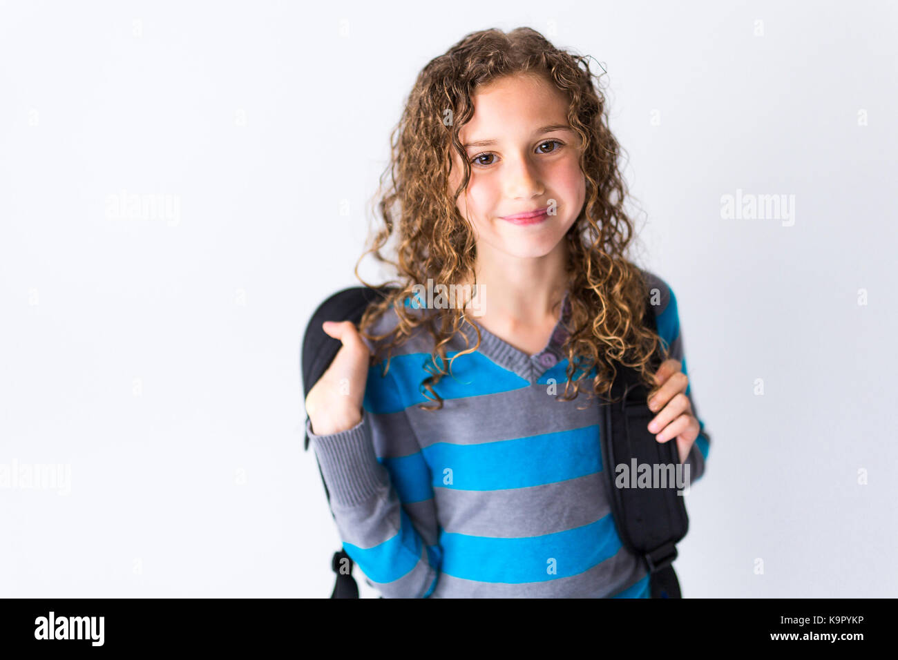 the girl of 9 years in a school uniform poses in studio Stock Photo - Alamy