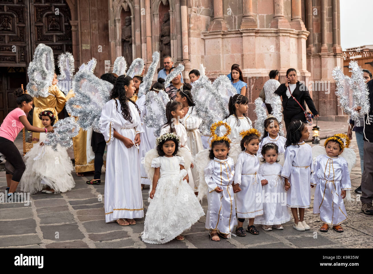 Young girls dressed as angels gather in front of the Parroquia de San Miguel Arcangel church at the start of the week long fiesta of the patron saint Saint Michael  September 21, 2017 in  . Stock Photo