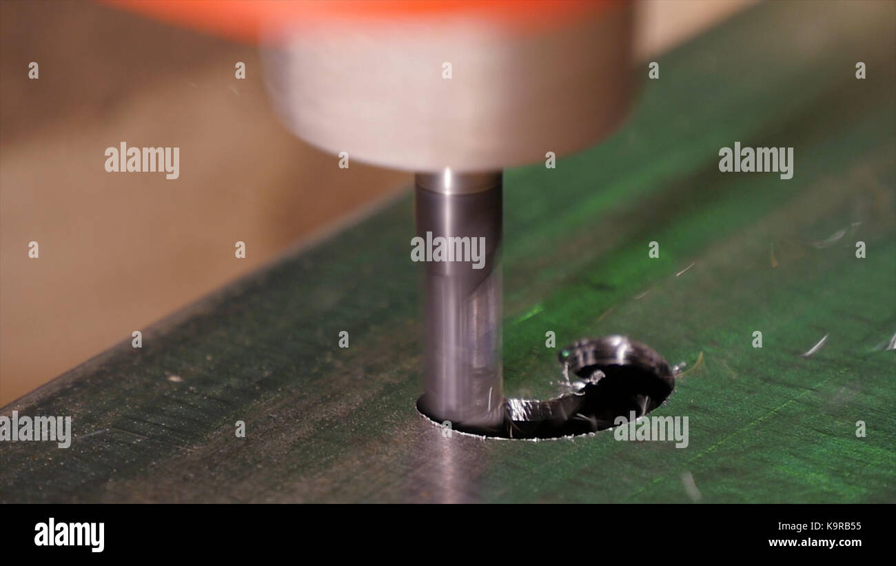 Hole being drilled into metal. Drilling closeup in metal